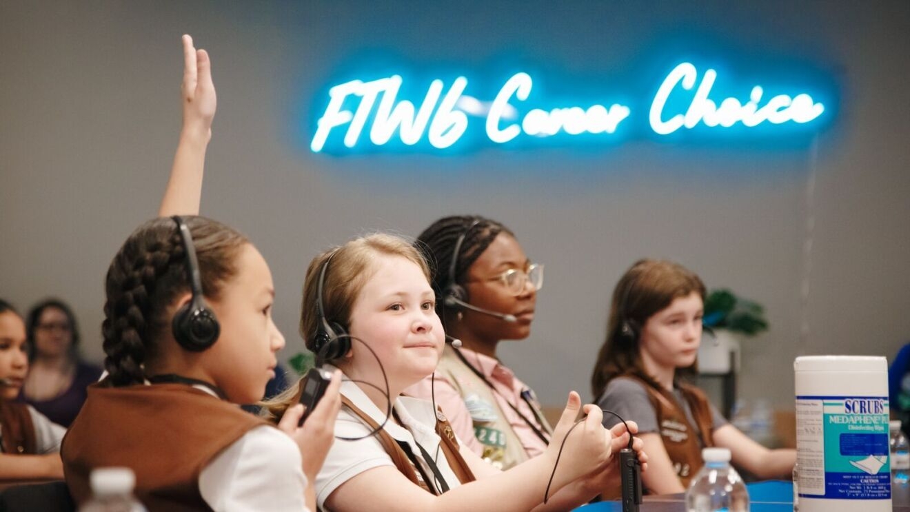 An image of Girl Scouts touring an Amazon fulfillment center.