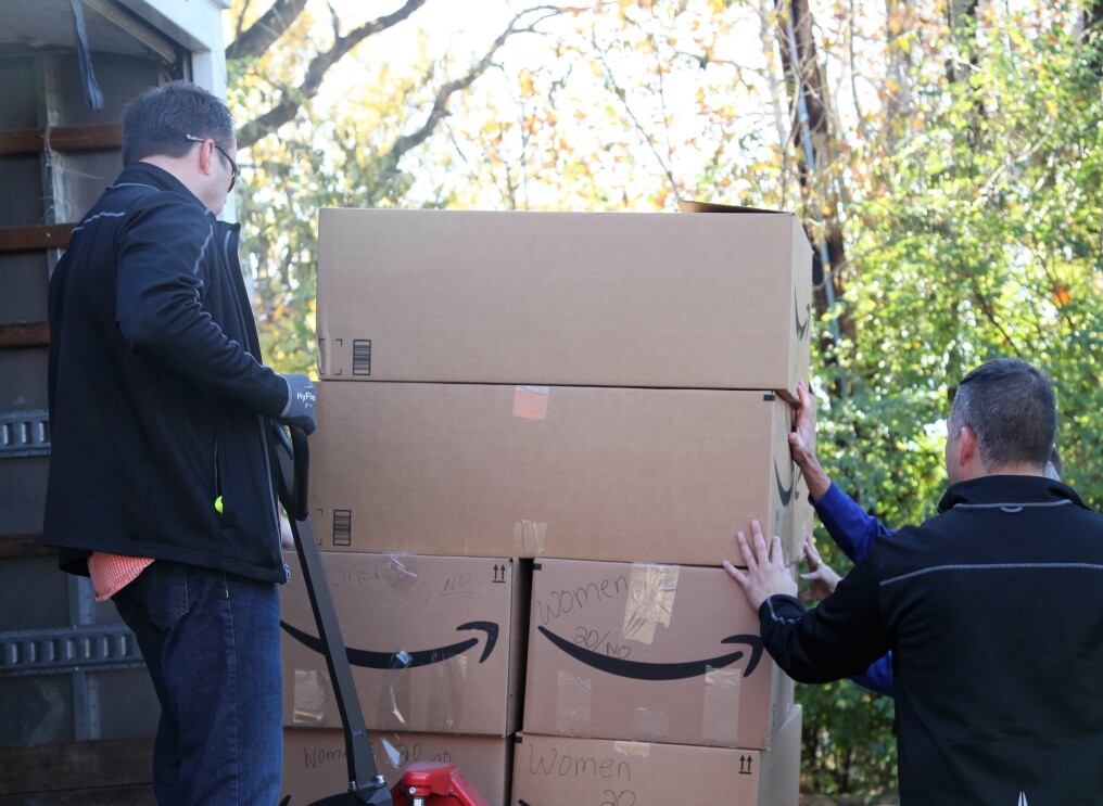 Amazon associates unload supplies for backpacks