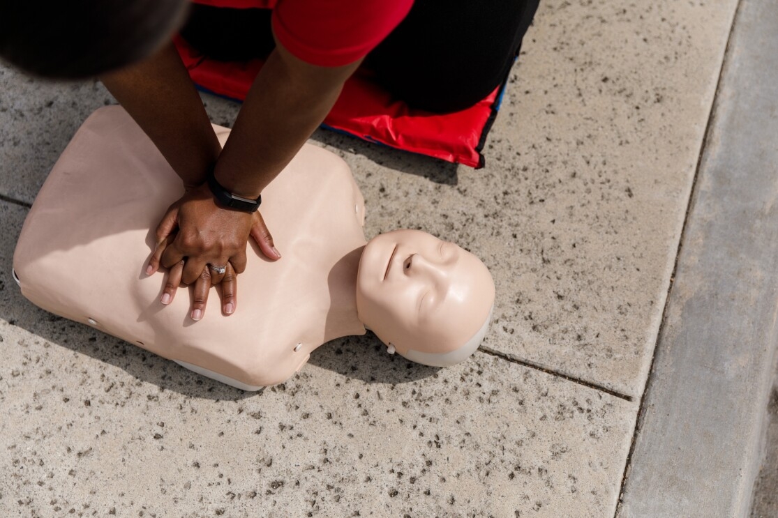 CPR instructor Jamie Davis demonstrates chest compressions