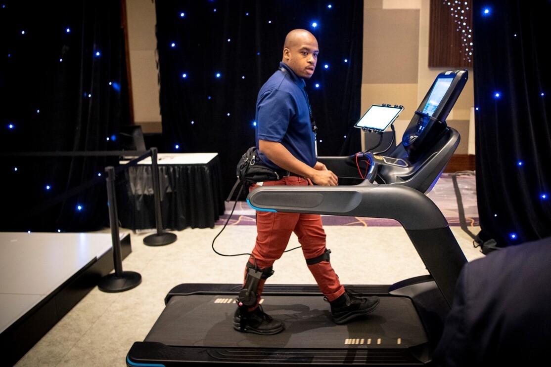 An image of a man walking on a treadmill with devices hooked up to him.