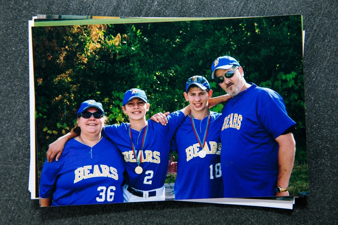 A family of four wearing softball uniforms adorned with the word "Bears."