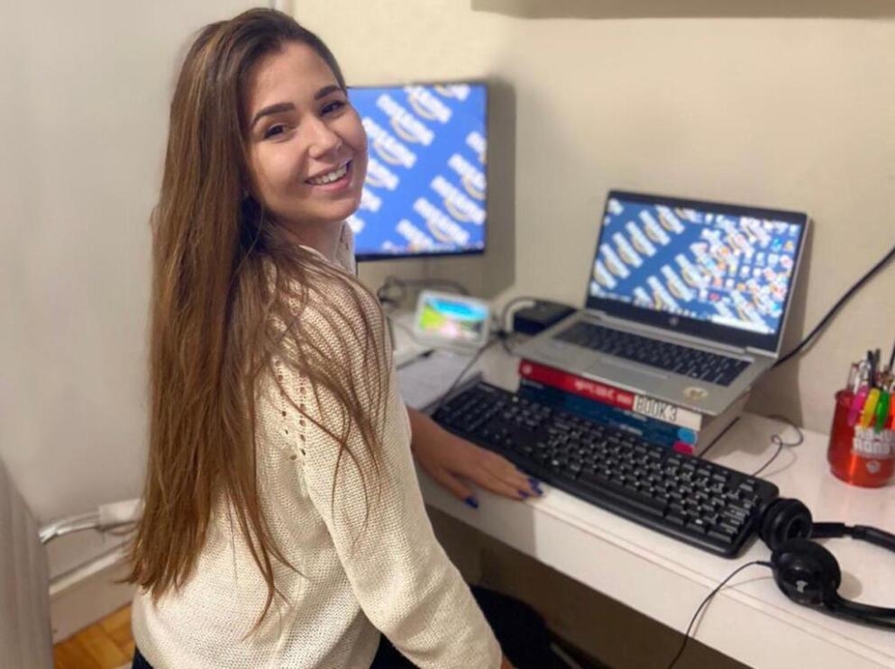 Gabrielle Martin, an intern at Amazon, smiles for a photo at her desk at home. 
