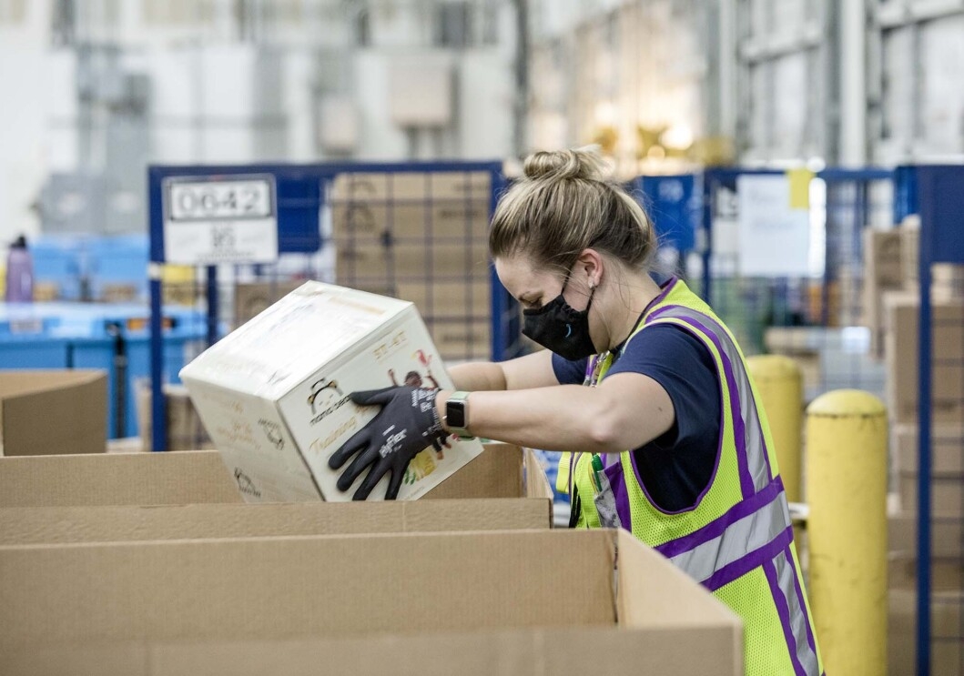 Person working with an Amazon Disaster Relief Hub prepares supplies for humanitarian and disaster relief efforts. 