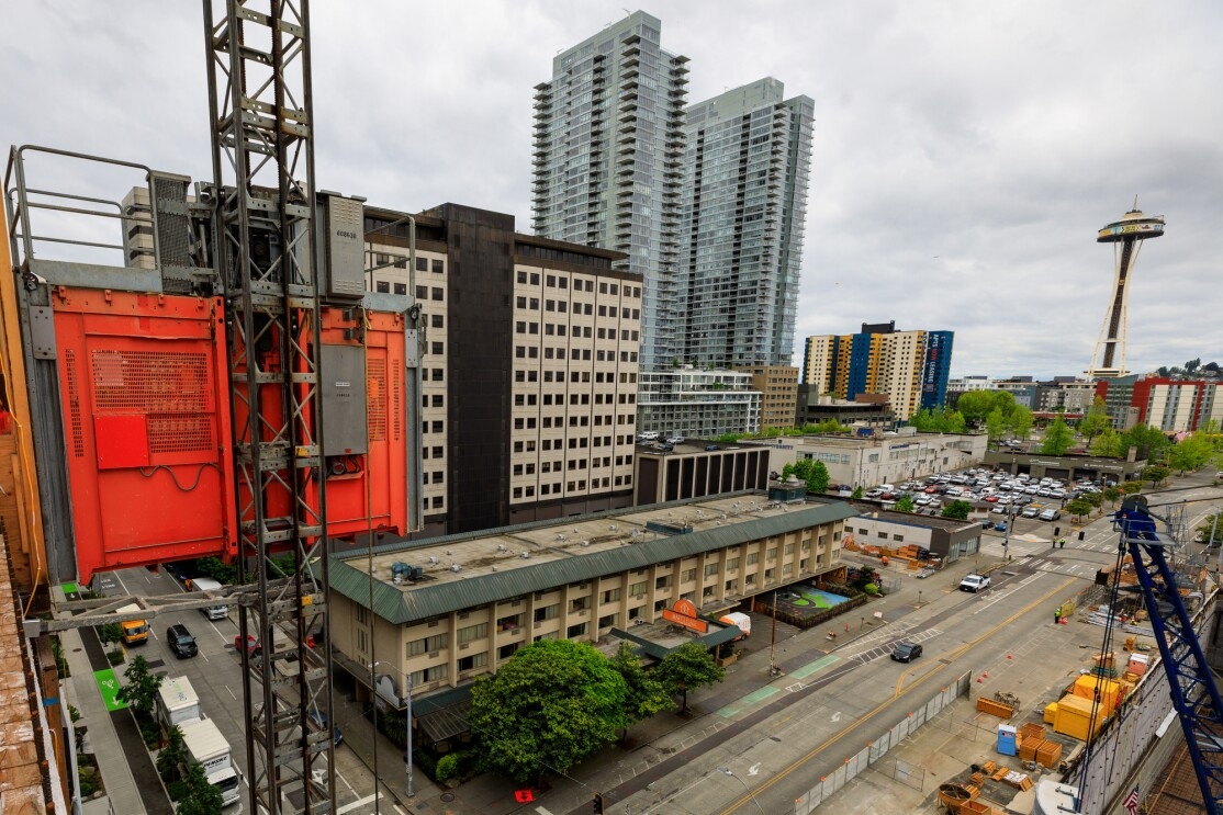 Buildings under construction on Amazon's South Lake Union campus. View from a building under construction, overlooking the former Mary's Place location, with the Space Needle in the background.