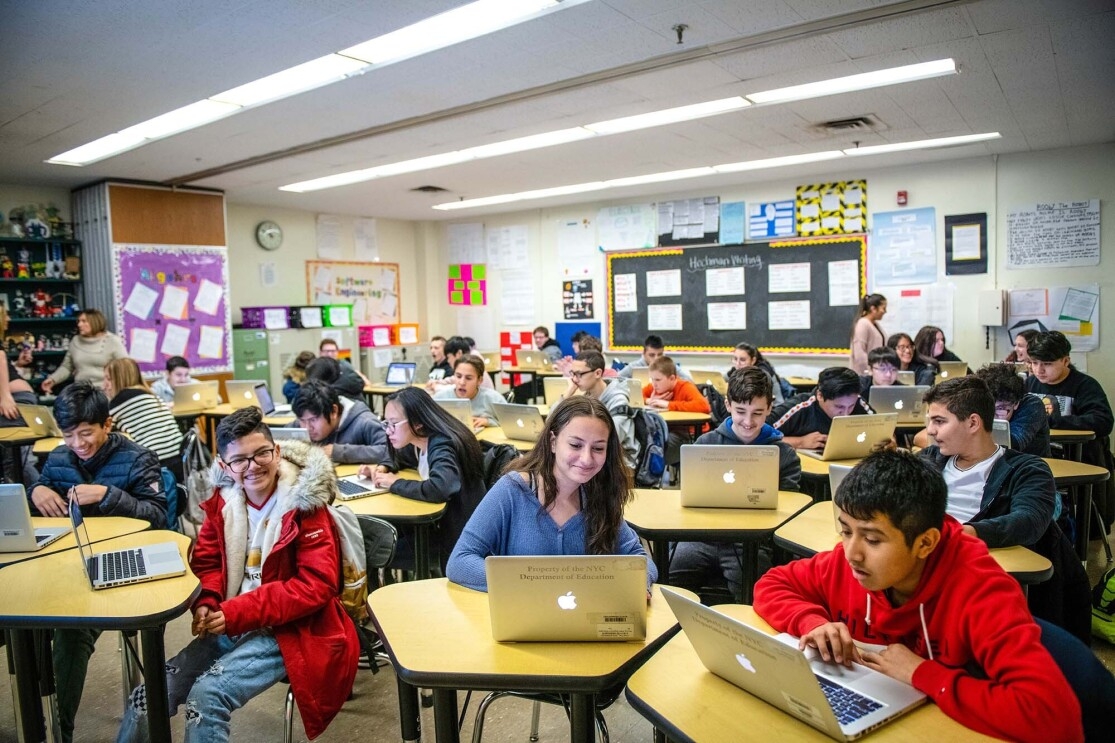 Students work on coding programs on laptop computers in a classroom at a New York City school. 