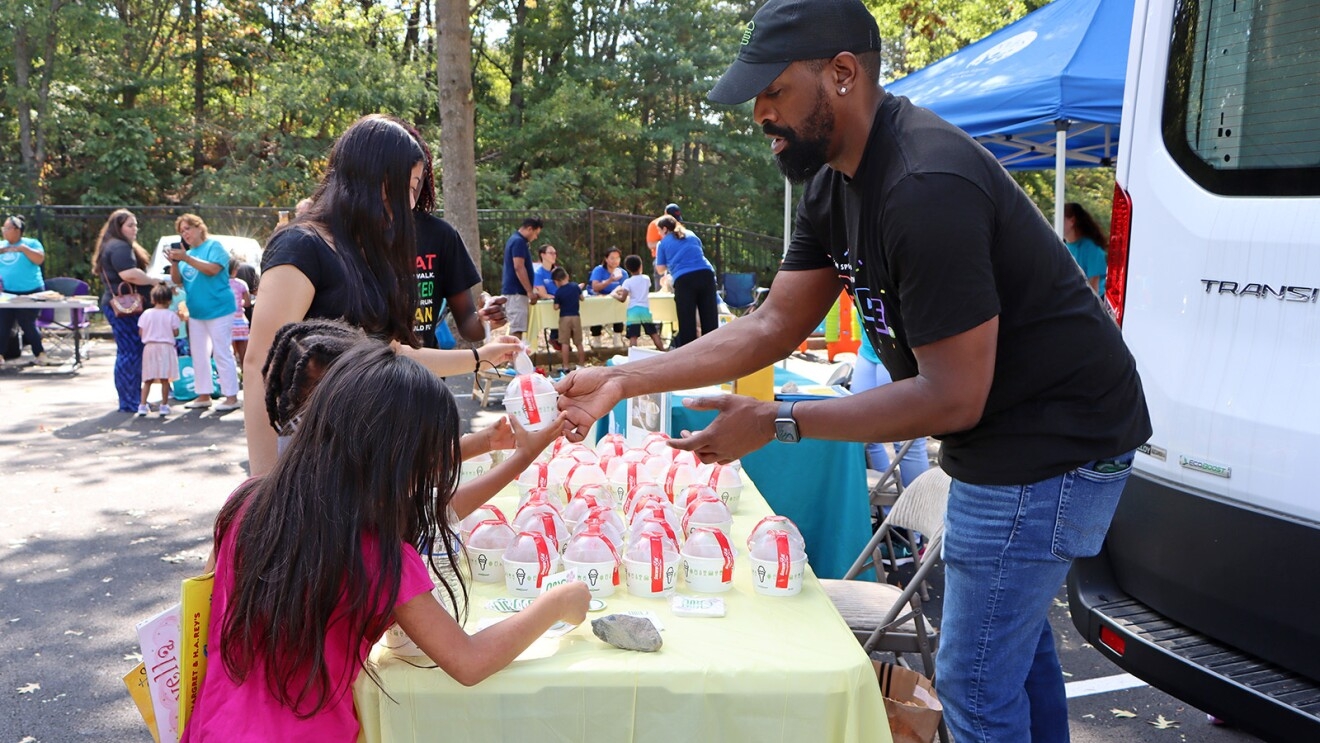 A photo of Northern Virginia Family Service (NVFS) and Amazon Web Services (AWS) hosting a food distribution pop-up event.