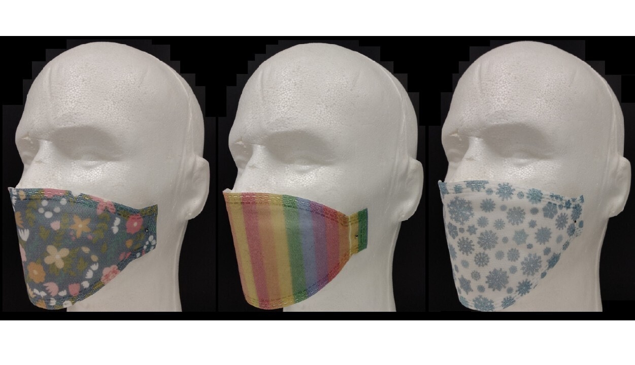 Three mask prototypes showcasing three different designs with colors, shapes, and patterns.