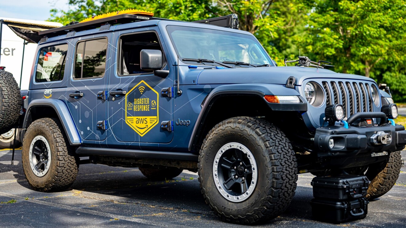 An image of a blue Jeep that says "Disaster Response AWS" in yellow on the side door.