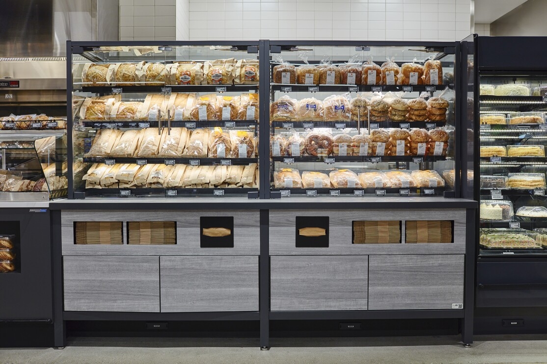 An image of a case in an Amazon Fresh bakery with breads and rolls inside of it.