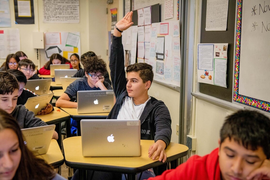 Students work on coding programs on laptop computers in a classroom at a New York City school. 
