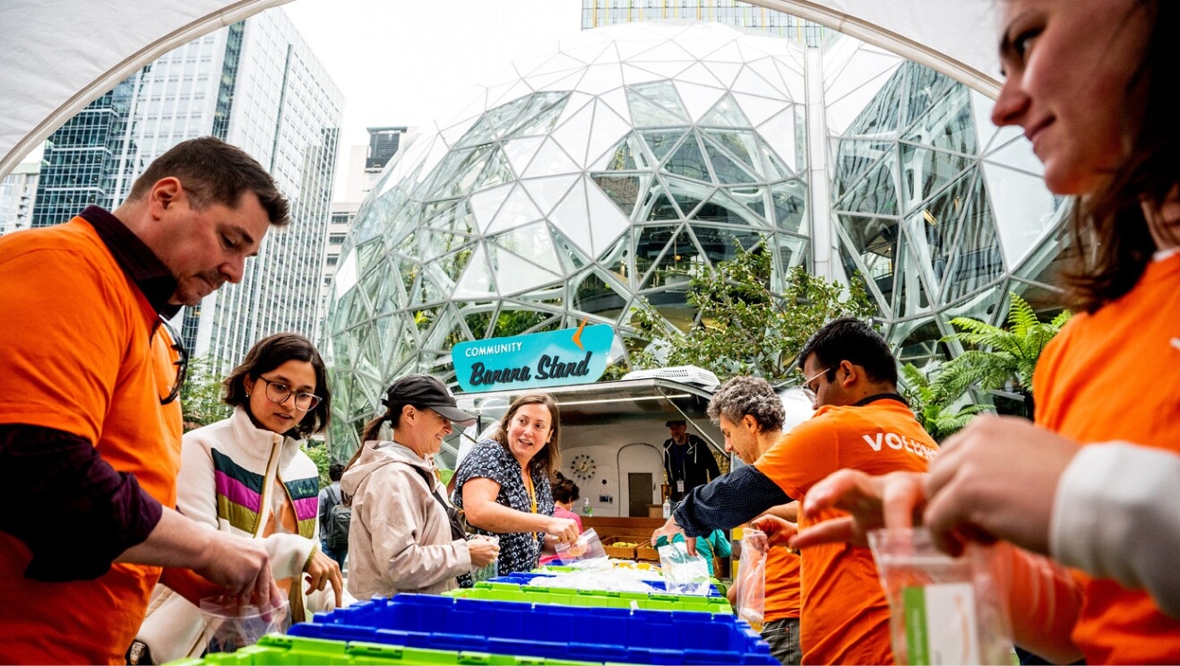 An image of a group joining together at the Amazon Web Services event at Amazon's headquarters in Seattle