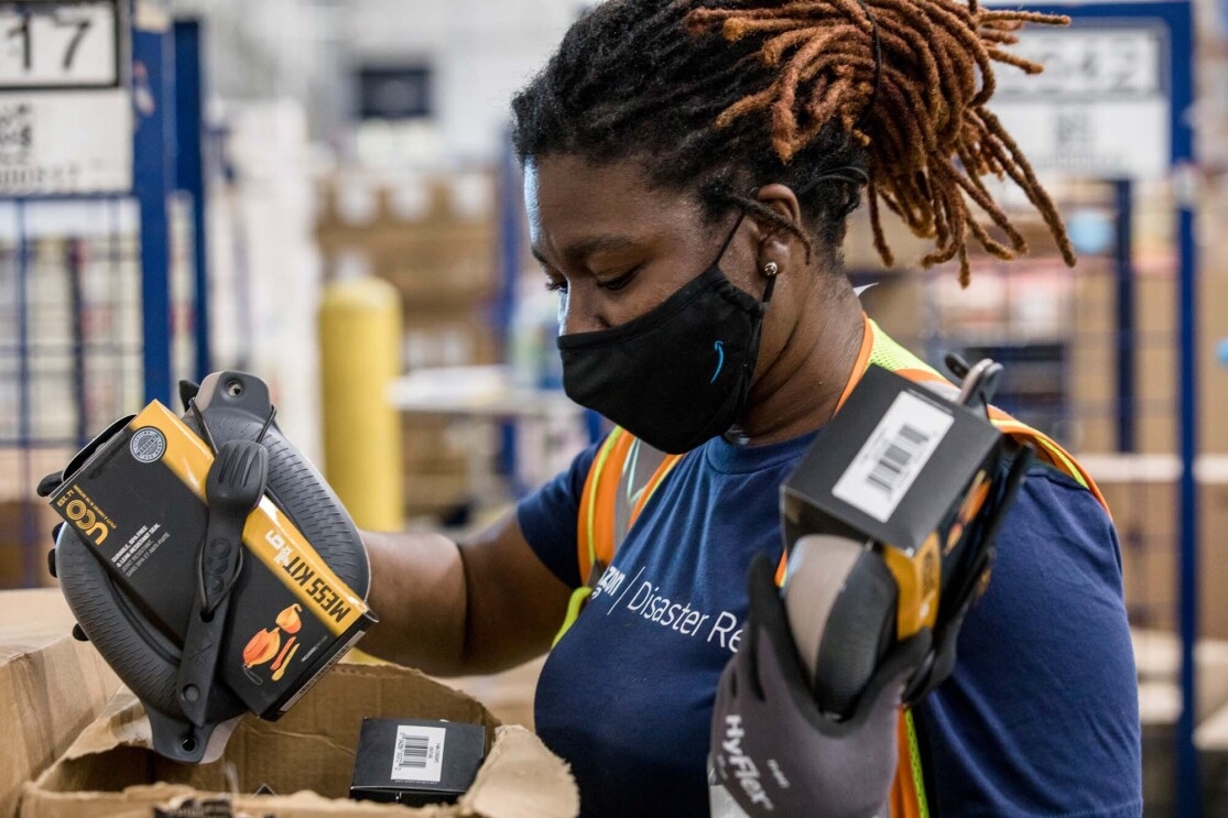 An Amazon employee readies product to be used for disaster relief. 