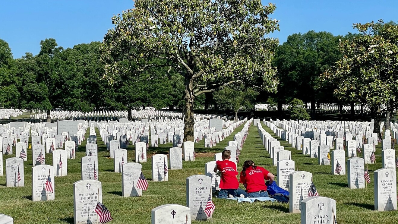 A military family honors their lost loved one at the Arlington National Cemetery. 