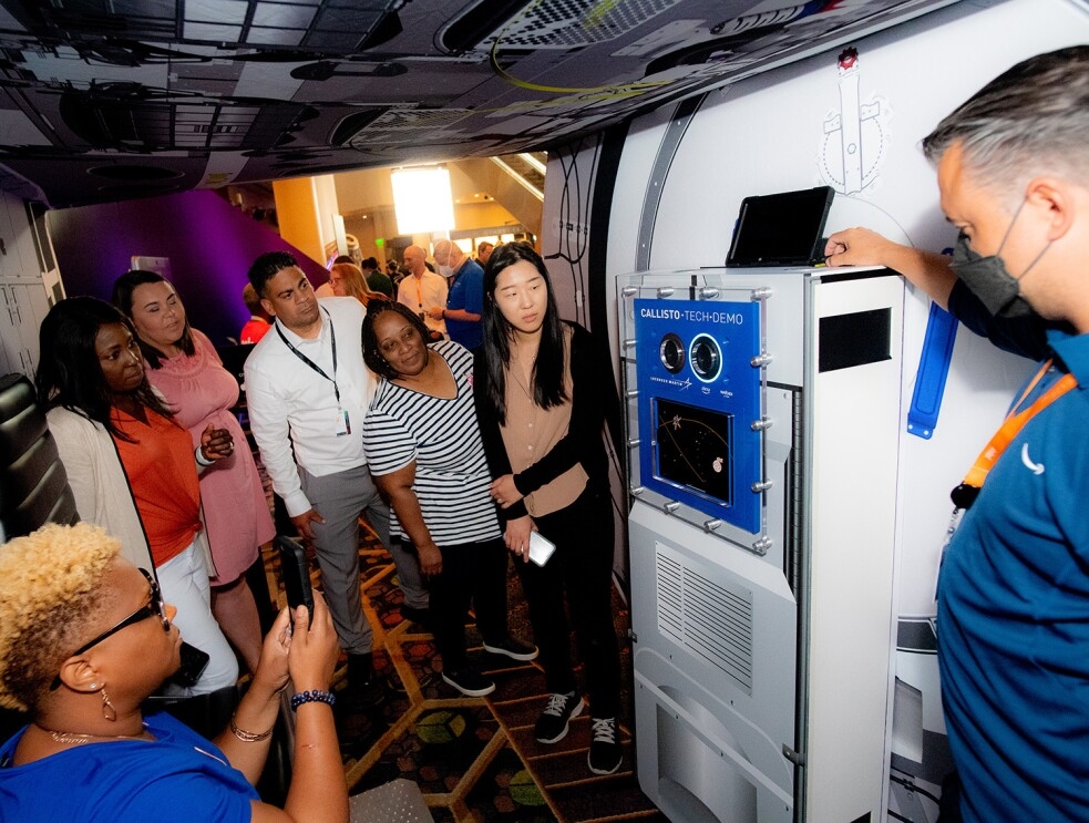 An image of the Teacher of the Year award winners checking out the mockup space shuttle at the re:MARS 2022 convention.