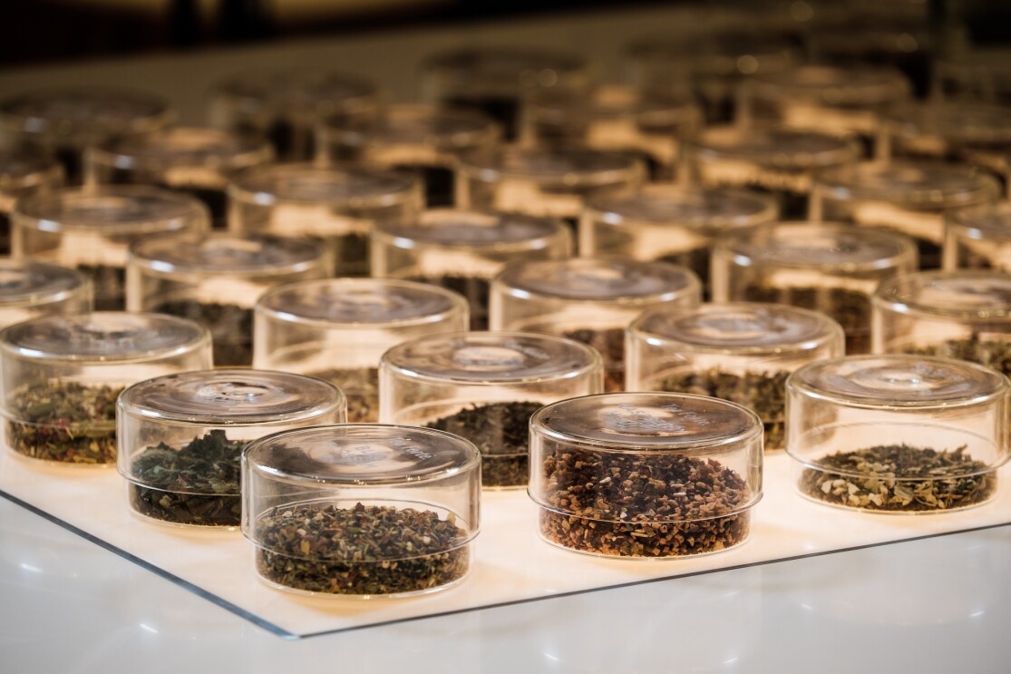 Glass containers filled with loose leaf tea.
