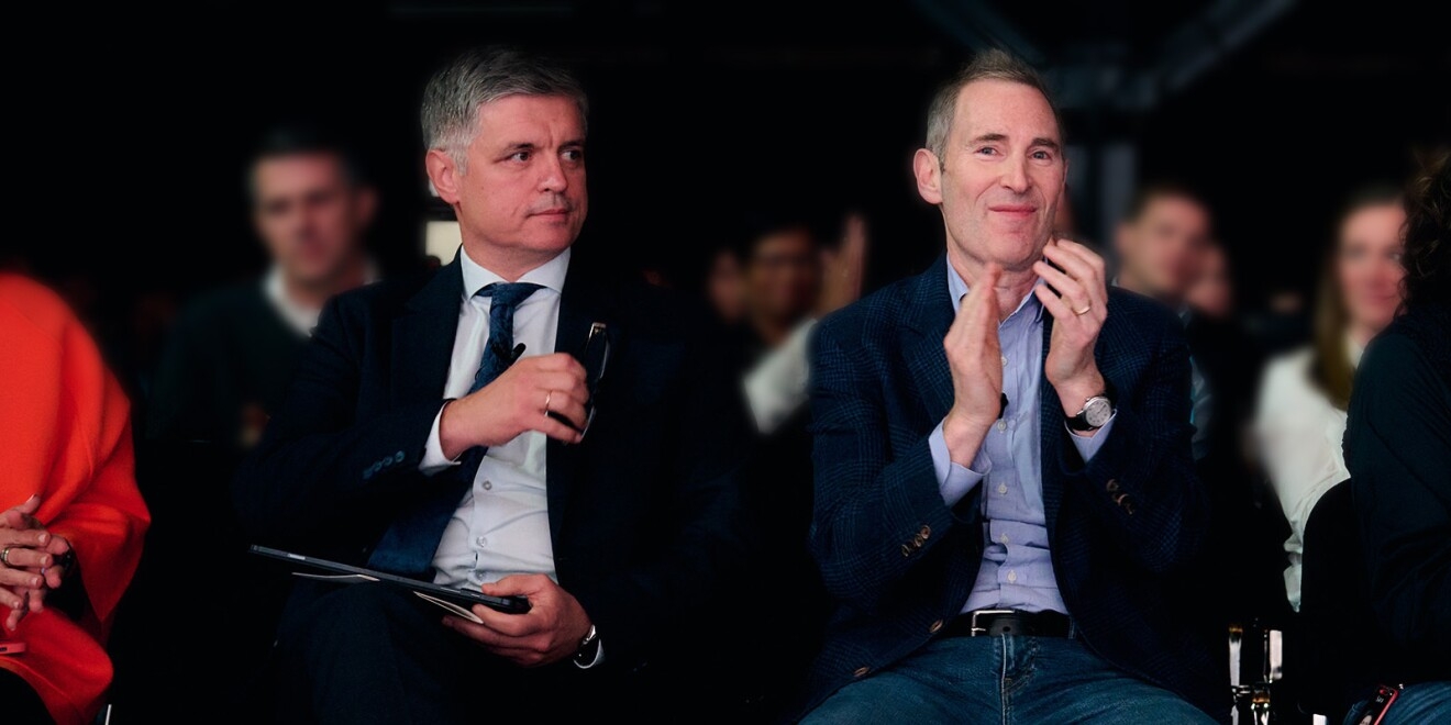 Ukraine’s Ambassador to the UK Vadym Prystaiko sits next to Andy Jassy in the audience of the all-hands company meeting in London. Andy Jassy smiles and claps as Prystaiko grabs his glasses from his pocket and is called to the stage.