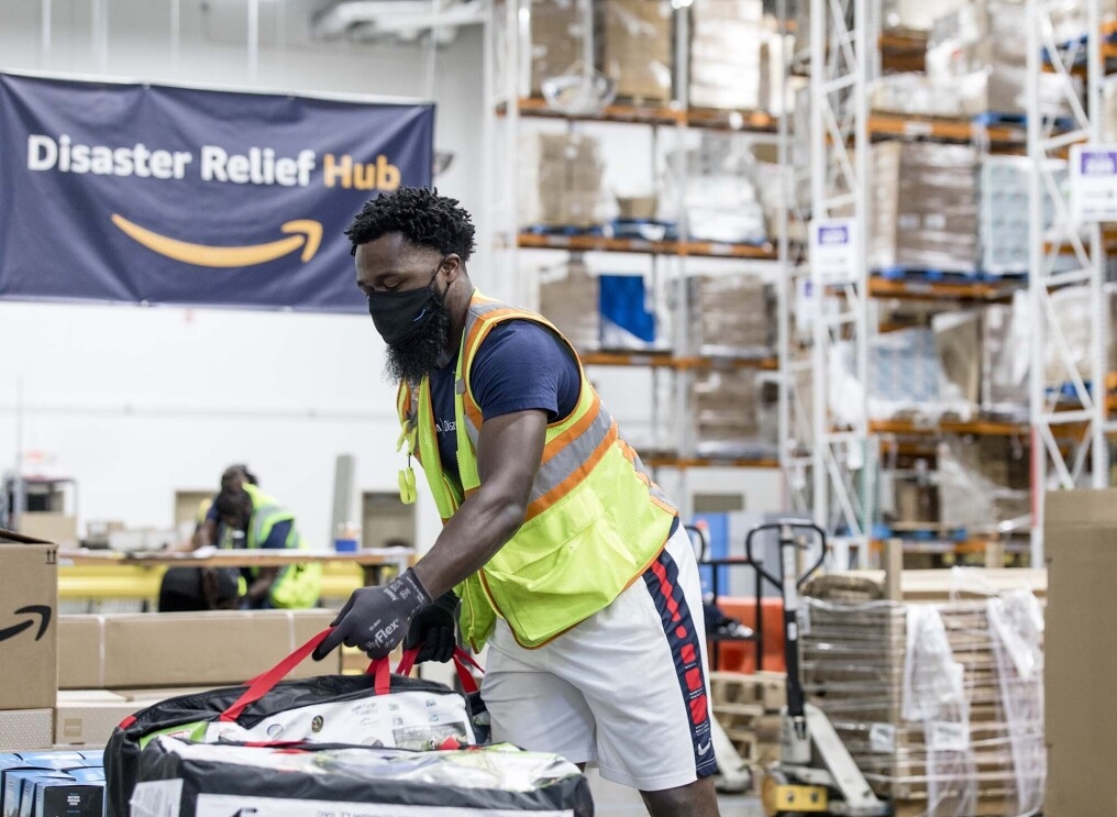 Person working with an Amazon Disaster Relief Hub prepares supplies for humanitarian and disaster relief efforts. 