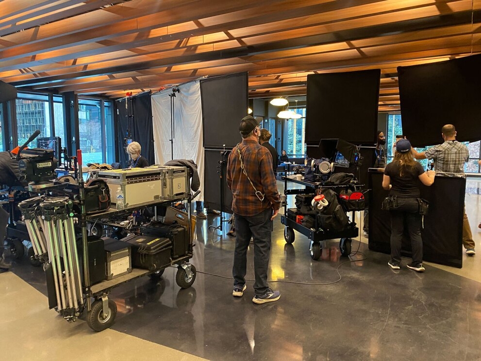 An image of a film crew filming in the lobby of Amazon's Day 1 building.