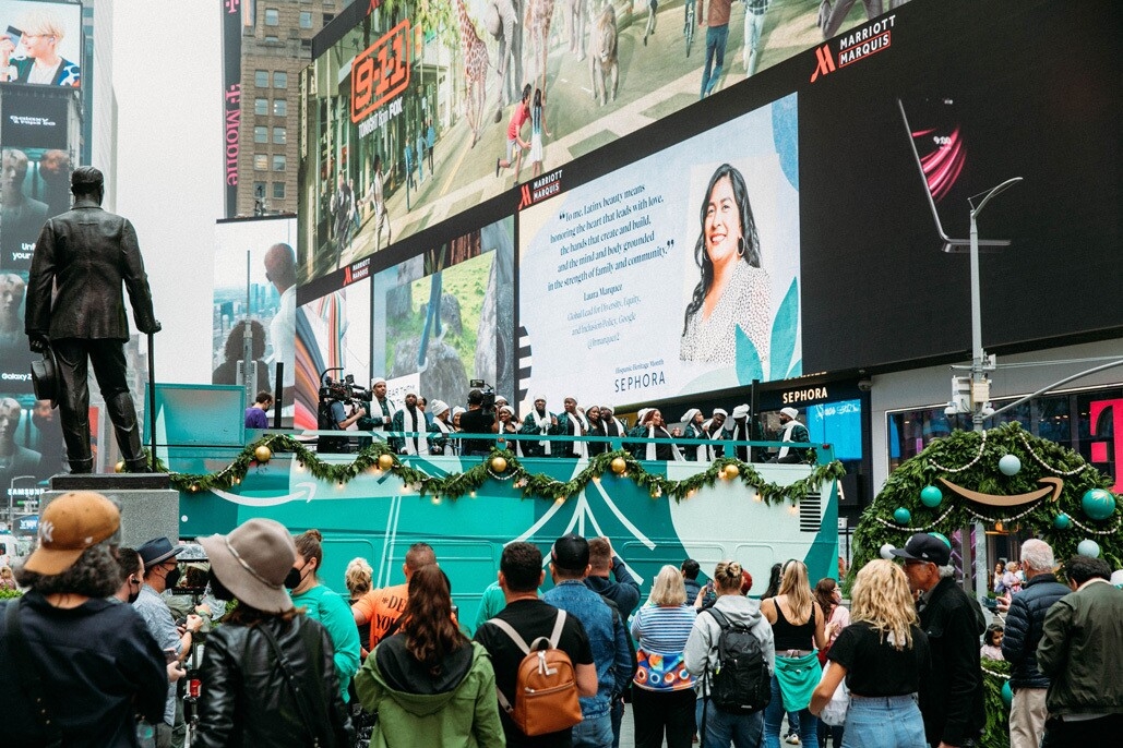 An image of the Harlem Gospel Choir on top of a green double-decker bus singing to crowds in New York.