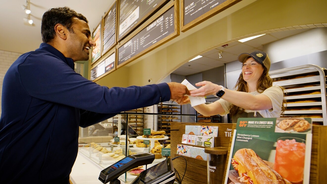 A man pays using Amazon One at a Panera store.