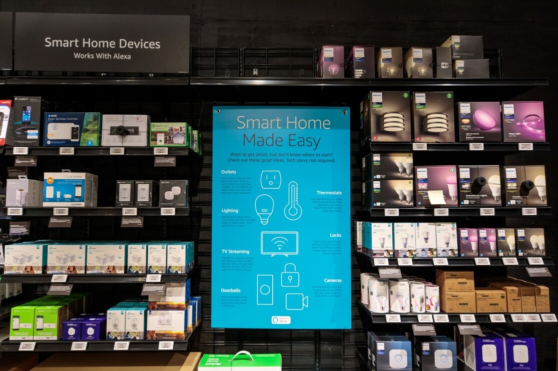 Smart Home Devices displayed in Amazon 4-star store. On a wall display, are outlets, thermostats, lighting, television streaming devices, doorbells, caperas and locks that are all able to connect digitally to Alexa-enabled devices.
