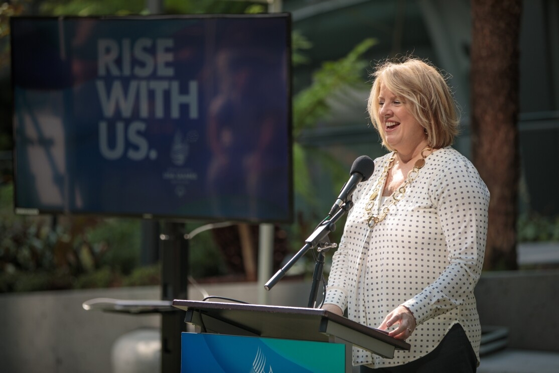 Beth Knox, President and CEO of Special Olympics USA Games, speaks to the crowd at Amazon.