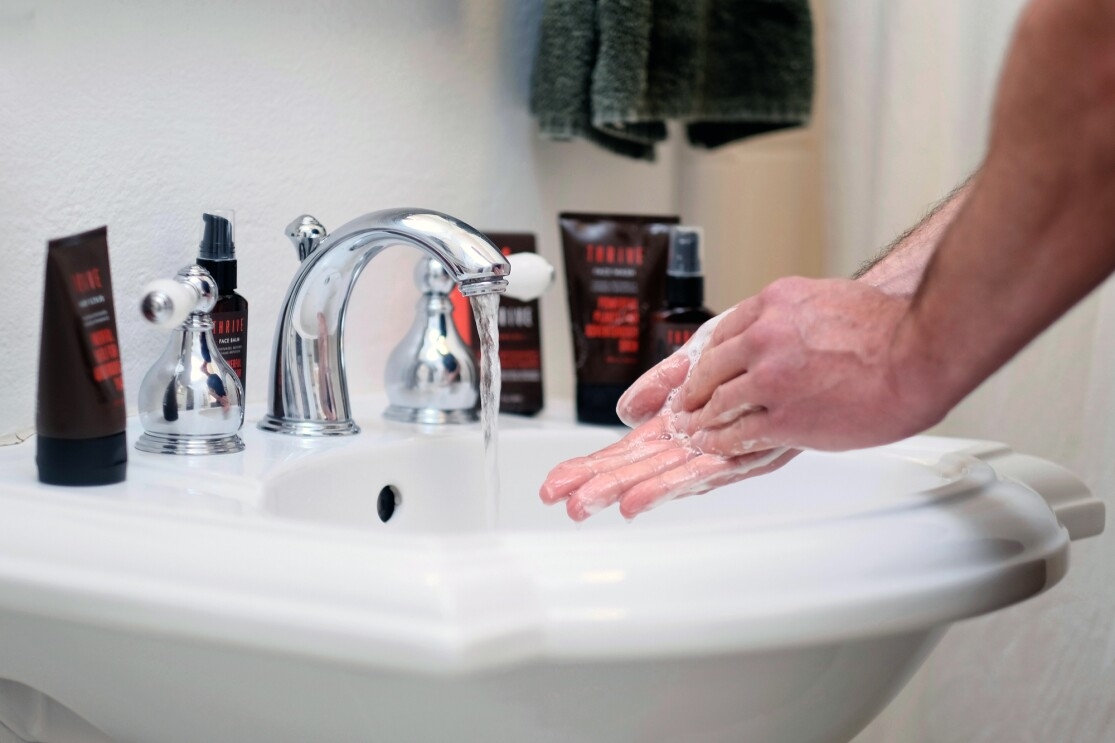 A man using Thrive Natural Care shave and skin-care products